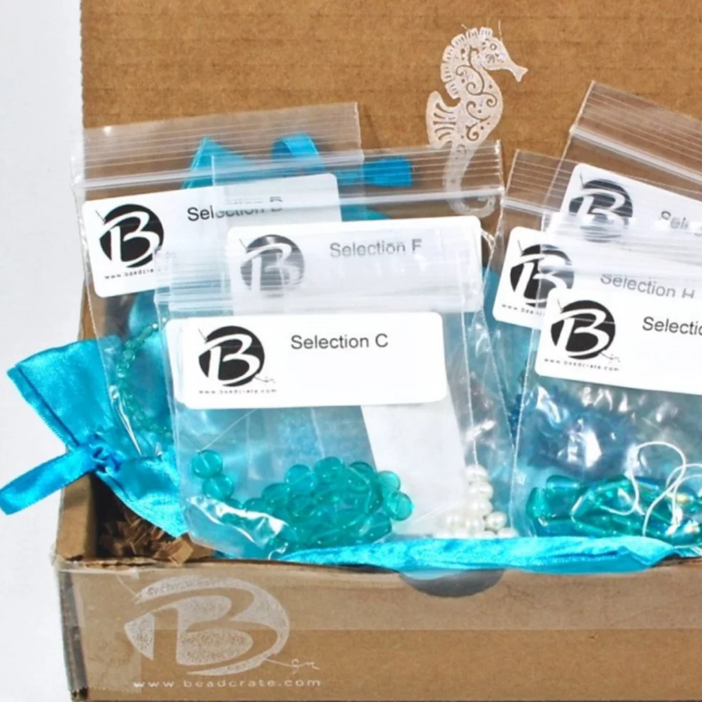Beading subscription box with sorted beads and jewelry-making components.