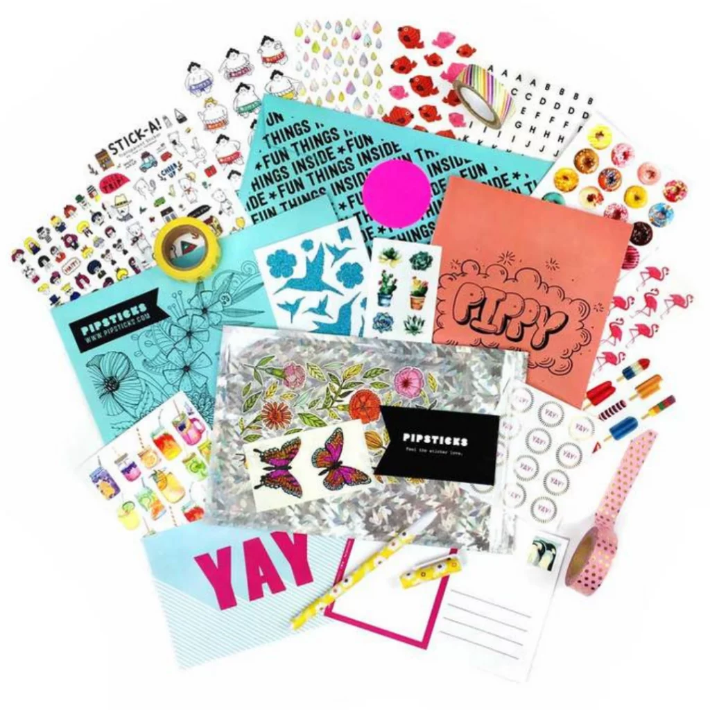 Assorted stickers, postcards and stationery in a craft subscription package.