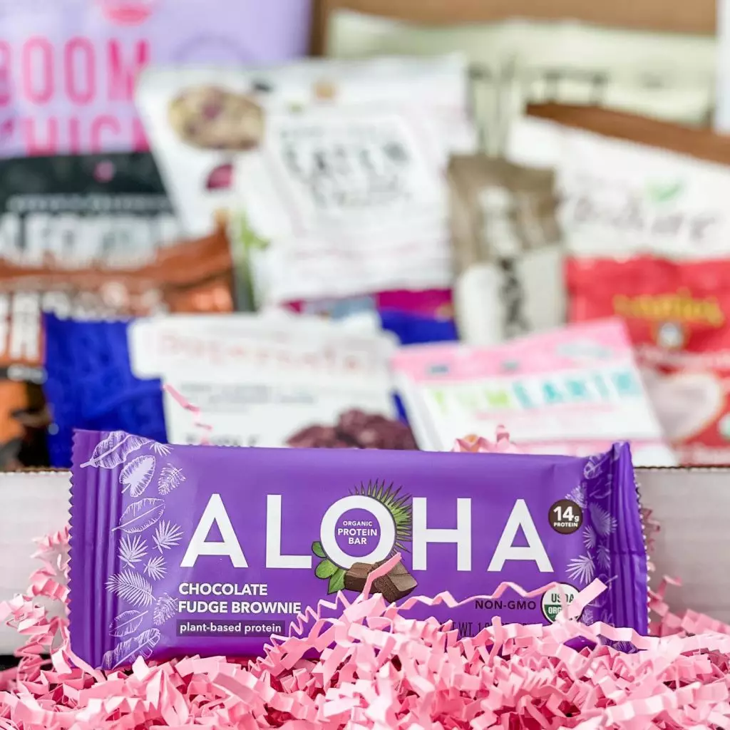 Subscription snack assortment featuring an Aloha chocolate bar.