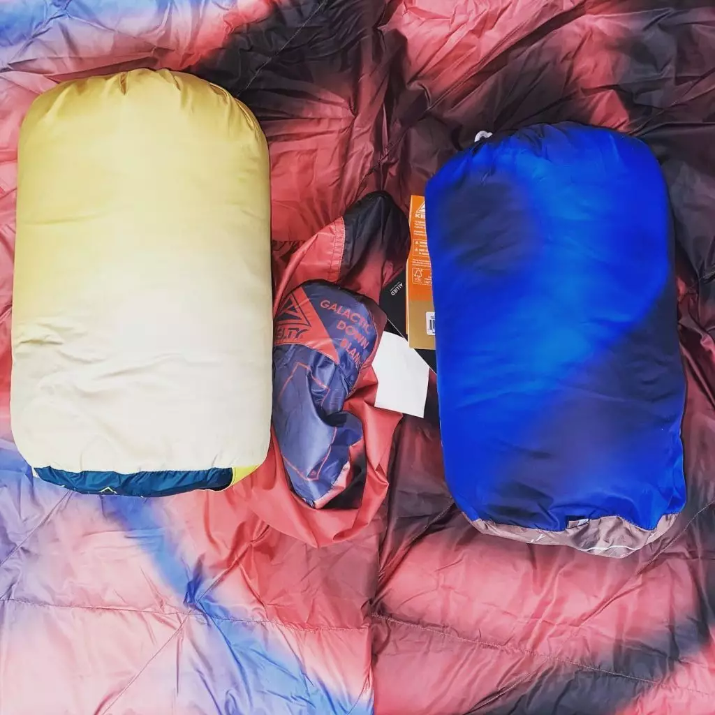 Packed camping accessories displayed on a colorful sleeping bag.