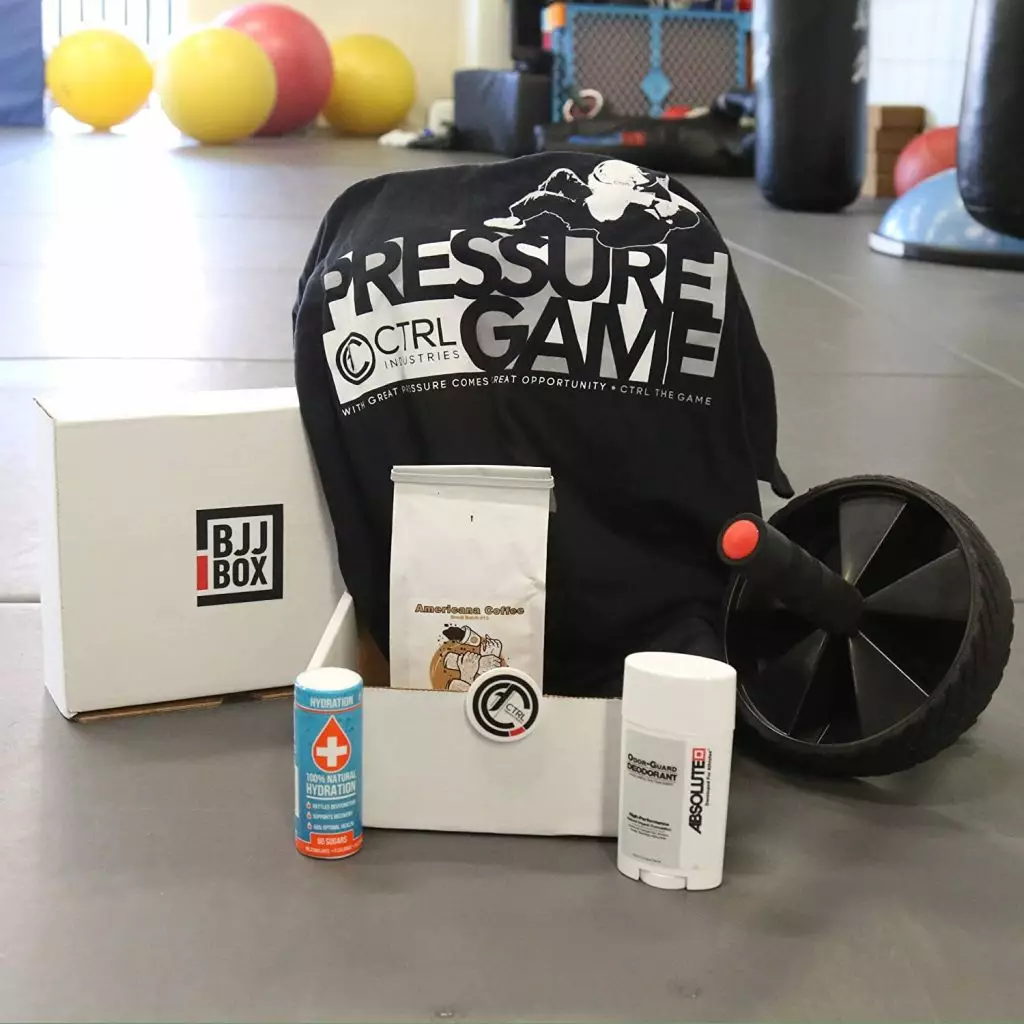 BJJ Box with a workout shirt, an ab wheel and personal-care products.