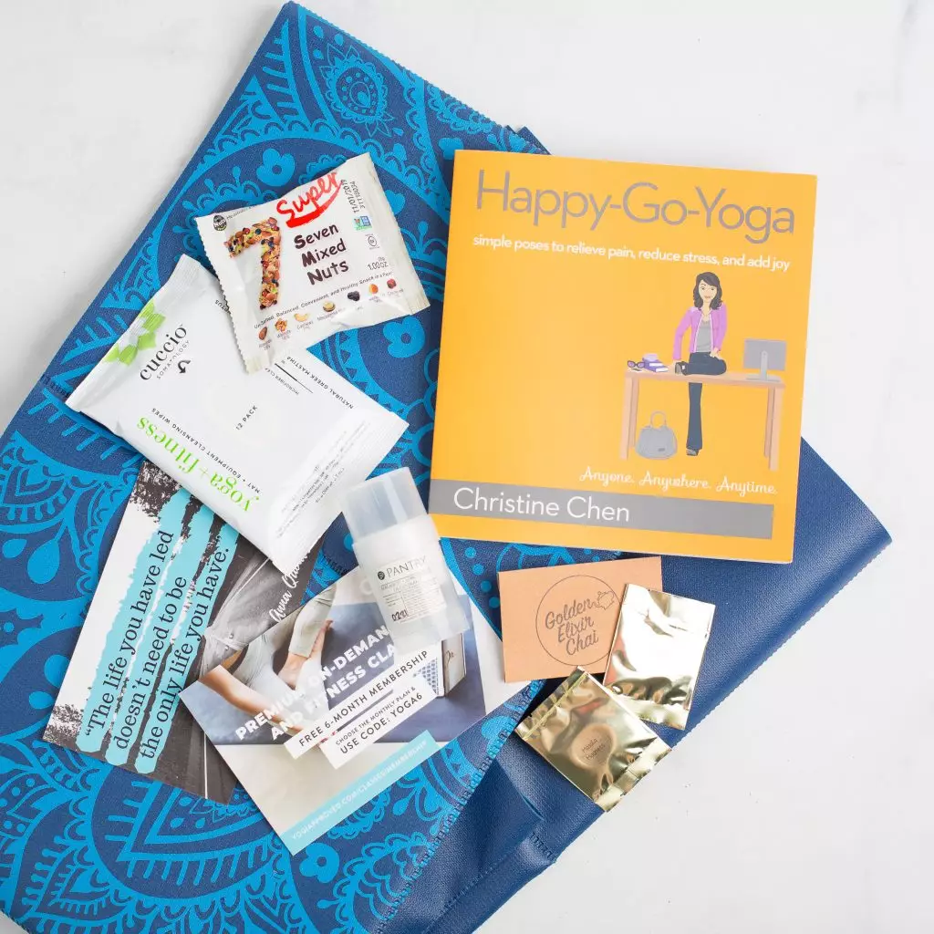 Yoga subscription package with a yoga book and self-care products.