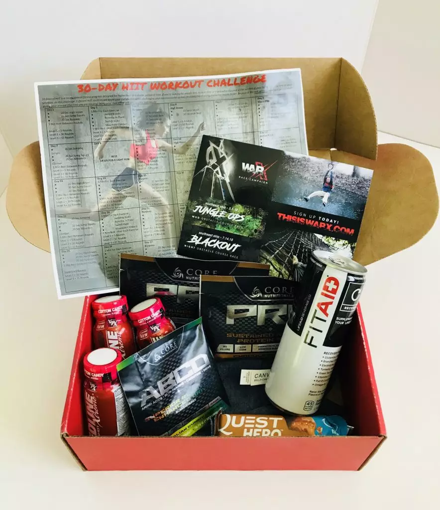 Fitness box containing supplements, snack bars and a workout challenge sheet.