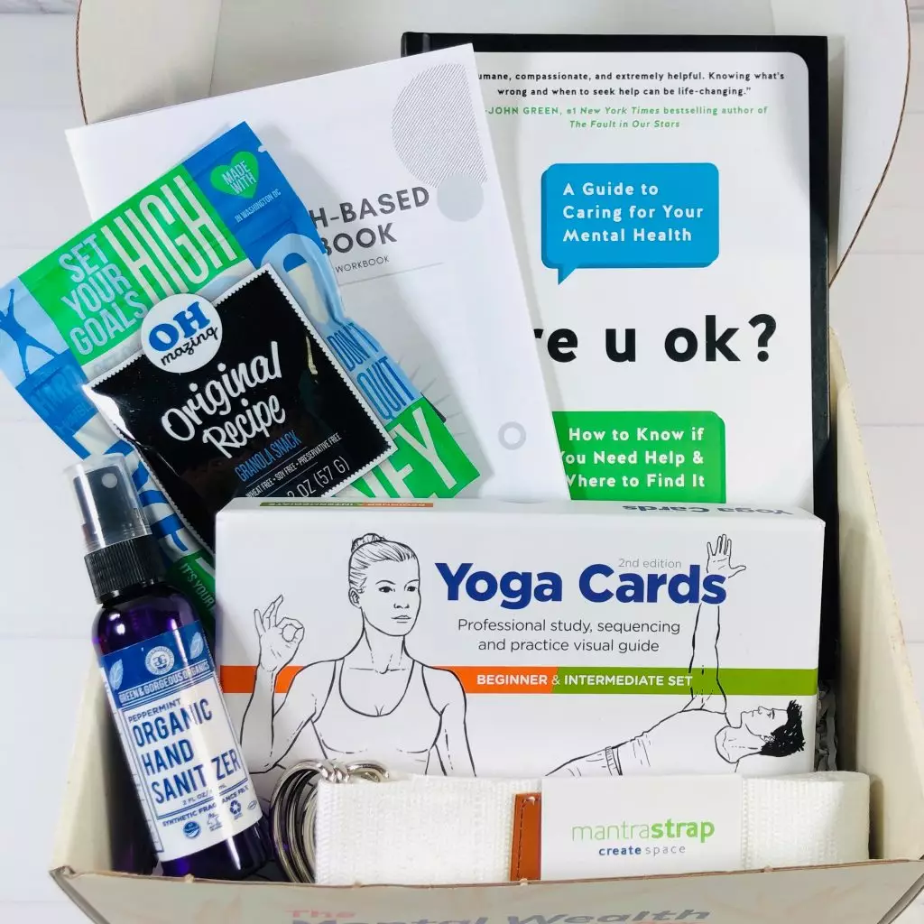 Wellness subscription box with mental-health guides and yoga cards.